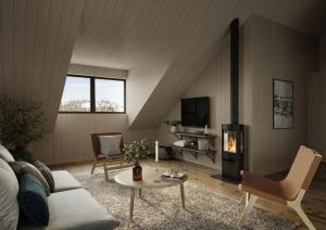 a living room with a couch and a fireplace at Tännäskröket in Tännäs