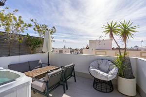 a patio with a table and chairs on a balcony at Luxury Penthouse apartment Nerja in Nerja