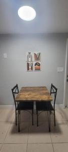a wooden table and two chairs in a room at Busch Gardens Bliss Retreat 1 Bedroom in Tampa