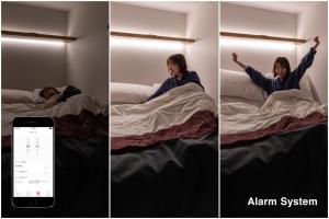 a woman laying in bed with her arms in the air at The Millennials Kyoto in Kyoto +37 photos