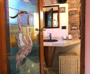 a bathroom with a glass shower door with a sink at Charming Apartment in Menaggio Old Town in Menaggio +57 photos