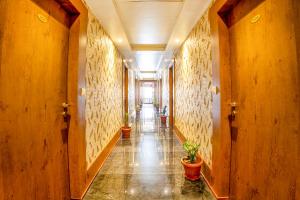 a hallway with potted plants in a building at FabHotel Phoenix Horamavu in Bangalore