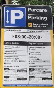 a parking sign in front of a parking lot at Kinsley Apartment 1 in Timişoara