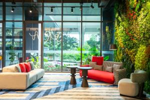 a lobby with couches and tables in a building at Hotel Faber Park Singapore - Handwritten Collection in Singapore