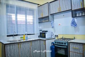 a kitchen with a sink and a stove top oven at Mupa's Luxury Condo II in Nyahururu