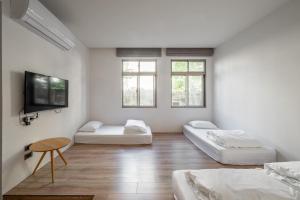 En eller flere senge i et værelse på Light Hostel Hualien