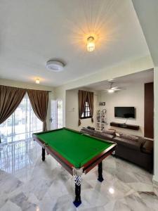 a living room with a pool table in it at Sarah homestay Muslim Permatang Pauh in Permatang Pauh