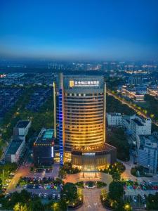 a view of a building with lights on at Jin Jiang International Hotel Taicang in Taicang