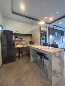 a kitchen with a large counter top in a room at Baan Fran Sim Da in Bang Tao Beach