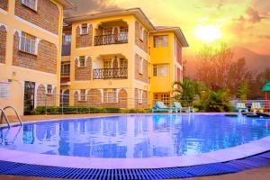 a large swimming pool in front of a building at Calabash Hotel, Migori in Migori
