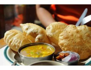 a plate of food with biscuits and a bowl of soup at Central Guest House, Tripura in Agartala