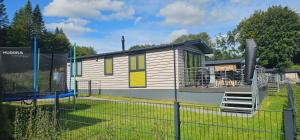 a small house with a playground in a yard at Ostseecamp Ferienhaus "Palm Beach" in Scharbeutz