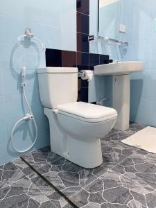 a bathroom with a toilet and a sink at Manju Homestay in Sigiriya