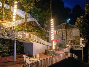 a staircase leading up to a house with lights at The Grey House Exotic Luxury-Villa in Bhīm Tāl
