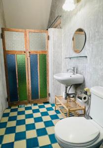 a bathroom with a toilet and a sink at The Backyard 28 in Khlong Toei