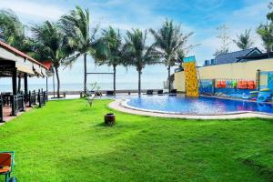 a resort with a pool and palm trees at Venus MuiNe in Mui Ne