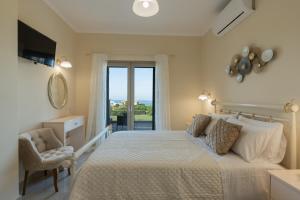 a bedroom with a bed with a view of the ocean at Aleli Villas with Tennis Court in Minia