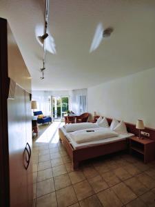 a bedroom with a bed and a living room at Landhaus Müller in Immenstaad am Bodensee