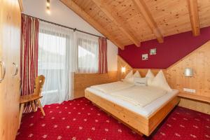 a bedroom with a bed and a red carpet at Gästehaus Sieder by Schladming-Appartements in Schladming