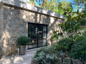 a stone house with a large glass window at Luxury Home Sweet Home Mougins in Mougins