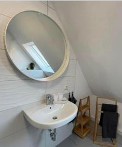 uma casa de banho com um lavatório e um espelho em Ferienwohnung mit WiFi und 2 Schlafzimmern em Ipsheim