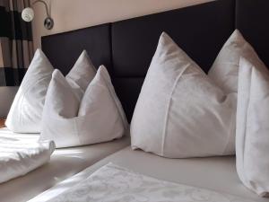 four white pillows sitting on top of a bed at Haus Valle in Reith bei Seefeld +29 photos