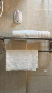 a bathroom with two towel racks with towels at فندق نزهة النسيم in Ash Shishah