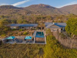 an aerial view of a resort with a swimming pool at Valley Lodge - Babanango Game Reserve in Dundee