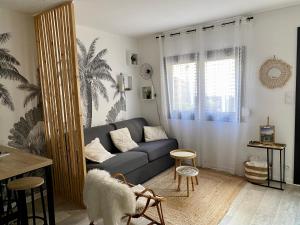 a living room with a couch and a dog in it at L’appart Duplex Bis in Le Havre