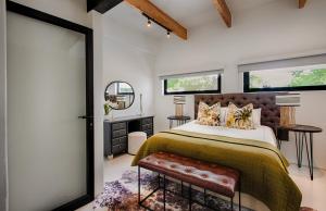 a bedroom with a large bed and a mirror at The Risa House in Muldersdrift +17 photos