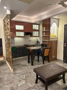 a kitchen with a table and a dining room at Tripur Sundari Nilaya in Vrindāvan