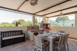 a dining room with a table and chairs and a kitchen at Aleli Villas with Tennis Court in Minia