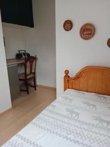 een slaapkamer met een bed en een bureau met een telefoon bij Chalupa u dědy in Dlažkovice