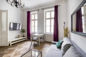 a living room with a couch and a table at Śliska Residence in Warsaw