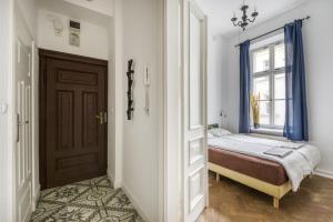 a bedroom with a bed and a window at Śliska Residence in Warsaw
