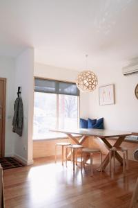 a dining room with a table and chairs and a window at The Wooden House in Bright