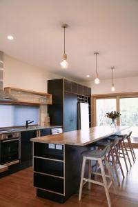 a kitchen with a large wooden table and chairs at The Wooden House in Bright