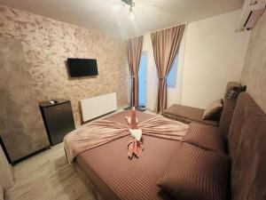 a woman laying on a bed in a bedroom at Ana Boutique in Constanţa