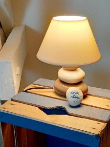 a lamp sitting on top of a blue table at chambres d'hôtes Au Gré du Vent en Normandie in Malleville-les-Grès