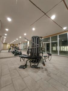 a gym with rows of tread machines in a building at Let's Go Homestay in Kuching