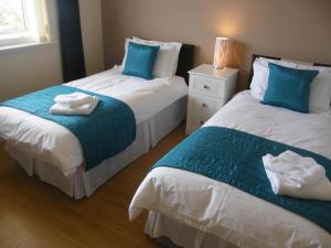 سرير أو أسرّة في غرفة في Elmbank Accommodation