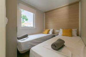 奇爾切斯的住宿－Camping tres estrellas Mediterráneo，一间卧室设有两张床和窗户。