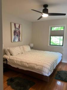 a bedroom with a bed with a picture of a dog at Schoolhouse No. 11 * Hudson Valley Upstate Getaway in Stone Ridge