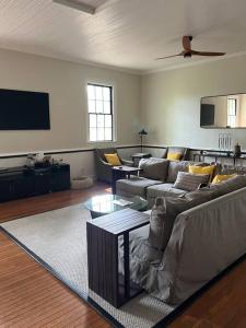 a living room with couches and a flat screen tv at Schoolhouse No. 11 * Hudson Valley Upstate Getaway in Stone Ridge