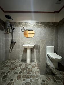 a bathroom with a sink and a toilet at El Nido Viewdeck Cottages in El Nido