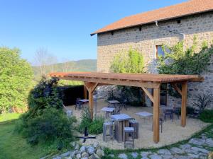 a wooden pergola in front of a building at Le Jardin des 4M in Saint-Régis-du-Coin +23 photos