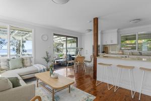 a kitchen and living room with a couch and a table at Bonus Studio Space in Budgewoi