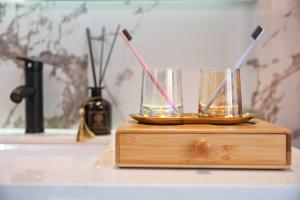 a wooden stand with two glasses on top of it at Moon River View Hotel in Fenghuang County