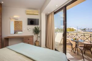 a bedroom with a bed and a balcony at Casa Lyristis in Faliraki