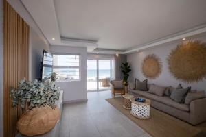 a living room with a couch and a table at The Blonde Bungalow Ballito in Ballito